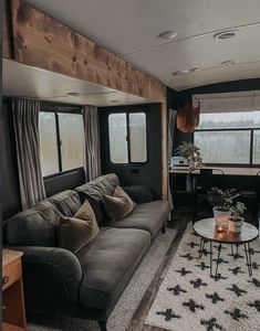 a living room filled with furniture next to a window covered in curtains and windowsills