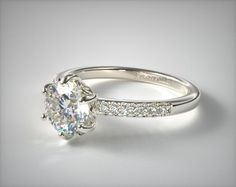 a diamond engagement ring on a white background