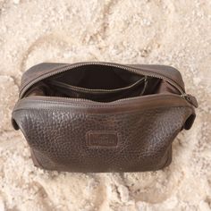 The Lucchese Dopp Kit is a perfect match to the overnight duffle or rolling duffle. An extra-wide zippered opening makes it easy to stash your essentials. Three interior pockets help keep small items organized on the road. A snap closure at both ends doubles as a handle. Features: 10" L x 5.5 " W x 6.5" H Constructed from full-grain pebbled cowhide leather Smooth leather trim and elbows contrast with the pebbled leather for interest and added strength at stress points Extra-wide opening for easy Rectangular Travel Case With Zipper Closure, Travel Case With Zipper Pocket Shaped As Pouch, Travel Case With Zipper Pocket, Rectangular Travel Cases With Zipper Closure, Functional Travel Bag With Zipper Closure For Storage, Brown Rectangular Travel Accessories With Zipper Closure, Functional Brown Weekender Bag With Zipper Closure, Brown Luggage With Zipper Closure For On-the-go, Brown Luggage For On-the-go