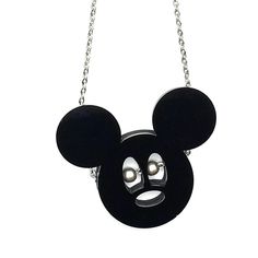 a black mickey mouse necklace with pearls on it's face and eyes hanging from a silver chain