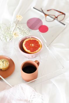 a table topped with plates and cups filled with food