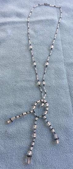 "Elegant cut crystal black and clear long tassel necklace. The necklace itself is about 26\" long and then the tassel pendant hangs another 5.5\" down from there, so the length on your chest is about 18.\" Also, please take a look at my storefront at: https://www.etsy.com/shop/FabFinds42?ref=seller-platform-mcnav I have a wide selection of one-of-a-kind items, from clothing and toys to home decor and gift items, and I add new things almost every day." Adjustable Black Beads Lariat Beaded Necklaces, Adjustable Lariat Beaded Necklace With Black Beads, Black Beaded Long Necklace With Round Beads, Black Beaded Necklace With Round Beads, Black Long Necklace With Round Beads, Black Beaded Lariat Necklace, Black Beaded Long Crystal Necklaces, Long Tassel Necklace, Orange Bracelet