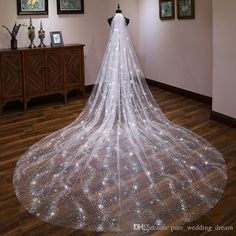 a white wedding veil with stars on the bottom is shown in front of a mirror