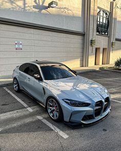 a silver car parked in front of a building