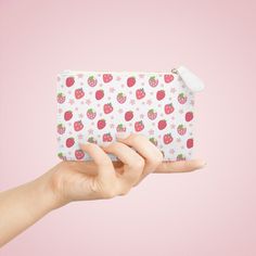 This compact Strawberries and Daisies Mini Clutch Bag is perfect for holding all your essentials on the go. Its cute and pretty design adds a touch of style to any outfit. With this handy bag, you can keep your belongings organized and easily accessible. Designed to be chic and highly portable, this mini clutch bag is made for anyone on the go. It can hold everyday essentials such as a phone, a wallet, and keys. It features a zip fastener and it is made of vegan, cruelty-free leather. .: Material: 100% polyurethane faux leather .: Double-sided print with Saffiano pattern finish.: One compartment for cash, cards, other small items.: Black lining.: Metal zipper closure 6.3” x 4” Width, in 6.30 Height, in 4.02 Depth, in 0.31 Cute Rectangular Coin Purse For Daily Use, Cute White Pouch Cosmetic Bag, Cute White Rectangular Pouch, Kawaii White Rectangular Pouch, Cute Rectangular Wallets For Everyday Use, White Portable Cosmetic Bag Gift, Cute White Rectangular Wallet, Portable White Cosmetic Bag As Gift, Portable White Cosmetic Bag For Gift