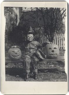 an old black and white photo of a clown sitting on a bench with pumpkins