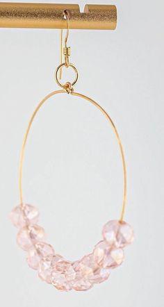 Discover the exquisite charm of our delicate pink glass & gold hoop earrings from Miel Jewelry. These stunning beaded hoop earrings feature light pink glass beads that shimmer with every movement, elegantly paired with delicate gold-filled ear wires. The perfect blend of casual and fancy, they are ideal pink hoop earrings for both special occasions and everyday wear. These lightweight pink statement earrings add a touch of sophistication and timeless elegance to any outfit. Elevate your style an Adjustable Gold Hoop Earrings With Faceted Beads, Pink Hoop Earrings With Dangling Beads For Gift, Gold Glass Earrings With Dangling Beads, Elegant Hoop Earrings With Faceted Beads, Elegant Gold Hoop Earrings With Faceted Beads, Hoop Jewelry With Faceted Beads, Pink Wire Wrapped Beaded Earrings With Round Beads, Pink Wire Wrapped 14k Gold-filled Jewelry, Pink Wire Wrapped Beaded Earrings