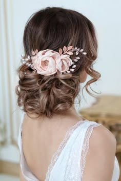 a woman wearing a hair comb with flowers on it's head and in the back