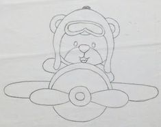 a drawing of a teddy bear on top of a propeller with a pilot's mask