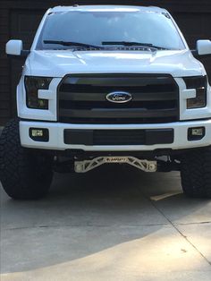 a white truck parked in front of a garage