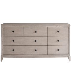 a white dresser with many drawers and black knobs on the bottom drawer, against a white background