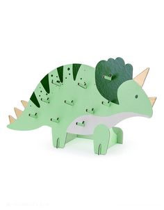 a green wooden dinosaur toy with spikes on it's head