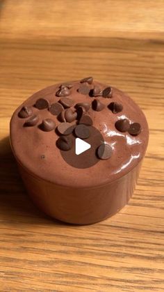 a chocolate cake sitting on top of a wooden table