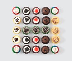 an assortment of cupcakes arranged in rows