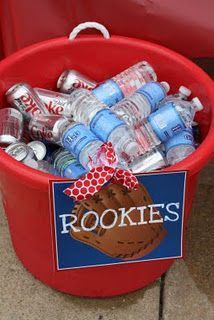 a red bucket filled with water bottles next to a sign that says rookies