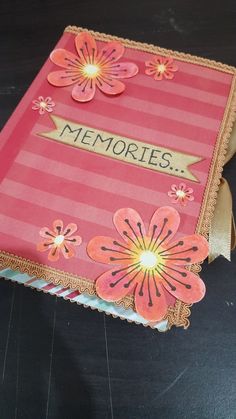 a pink and gold card with flowers on the front that says memories in black lettering