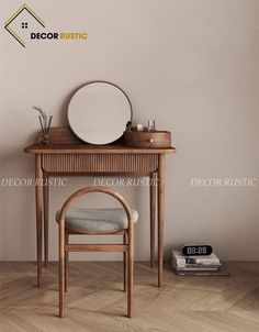 a wooden table with a mirror on top of it next to a chair and book