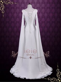 a white wedding dress with long sleeves and laces on the neckline is shown in front of a purple background