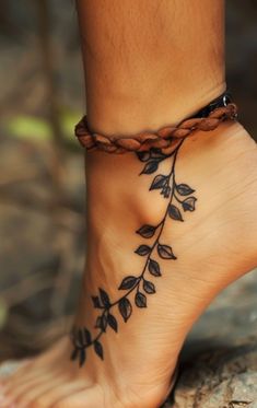 a woman's foot with a tattoo on it