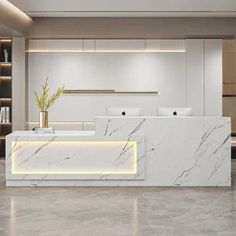 an office lobby with marble counter tops and white walls, illuminated by recessed lighting