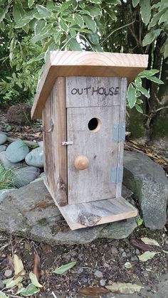 a birdhouse with the word outhouse written on it