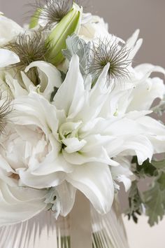 a bouquet of white flowers in a glass vase