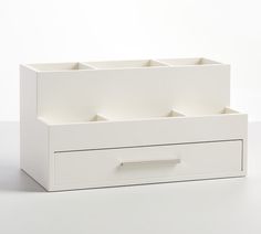 a white drawer with three compartments on the bottom and one section open to show drawers