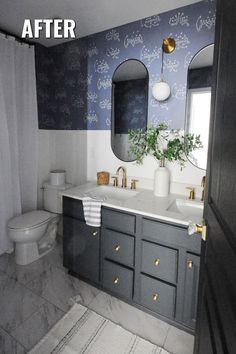 a bathroom with blue and white wallpaper on the walls, two sinks and a toilet