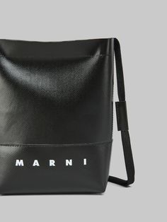 Crossbody bag with shoelace-style shoulder strap. Zip closure. Front Marni logo print. Palladium hardware. Black Shoulder Bag With Logo Hardware In Coated Canvas, Black Coated Canvas Shoulder Bag With Logo Hardware, Coated Canvas Shoulder Bag With Logo Strap, Designer Bags With Logo On Coated Canvas, Designer Bag With Logo In Coated Canvas, Designer Bags In Coated Canvas With Logo, Designer Coated Canvas Bags With Logo, Designer Logo Bags In Coated Canvas, Modern Coated Canvas Shoulder Bag With Logo