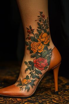 a woman's foot with flowers and leaves tattooed on the side of her shoe