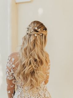 the back of a woman's head wearing a wedding dress