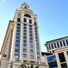 a very tall building sitting next to other buildings