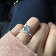 a woman's hand with a diamond ring on it