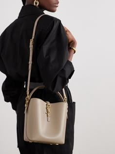 SAINT LAURENT's iconic 'YSL' hardware can even double as a clasp. A feature on this small 'Le 37' bucket bag, the brushed gold-tone metal stands out beautifully against the smooth leather, while the coordinating feet deter wear and tear. Stash your phone, keys and cardholder inside, using the detachable strap to sling it over your shoulder. Small Bucket Bag, Colorful Handbags, Small Buckets, High Fashion Looks, Woman Style, Raffia Bag, Winter Beauty, Ballet Pumps, Leather Bucket Bag