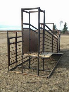 a horse trailer sitting on top of a dry grass field