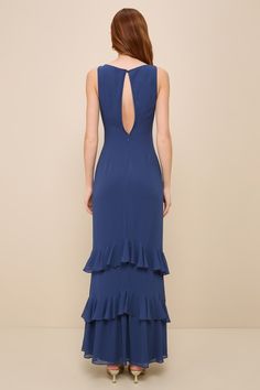 Make your entrance with the utmost confidence in the Lulus Lovely Arrival Dark Blue Chiffon Ruffled Tiered Maxi Dress! This elegant dress has an airy woven chiffon composition that shapes a princess-seamed bodice with a boat neckline and a sleeveless silhouette. Fitted waist features flattering gathering at the sides before continuing into a tiered maxi skirt with playful ruffles. A top button closure at back sits atop an alluring cutout. Hidden back zipper/clasp. Fit: This garment fits true to Fitted Maxi Dress With Ruffle Hem For Wedding, Elegant Tiered Maxi Dress For Prom, Elegant Tiered Evening Dress For Prom, Elegant Tiered Prom Evening Dress, Fitted Chiffon Mother Of The Bride Dress For Gala, Blue Ruffled Evening Dress For Bridesmaids, Elegant Tiered Maxi Dress For Wedding Guest, Blue Tiered Maxi Dress For Wedding, Elegant Bridesmaid Maxi Dress With Ruffle Hem