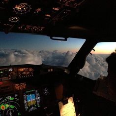 the view from inside an airplane looking out at clouds and planes flying in the sky