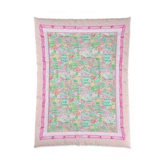 a pink and green quilt on a white background