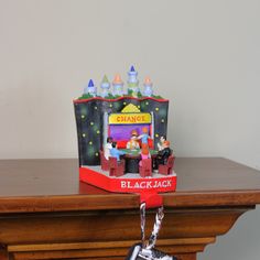 a black jack keychain on top of a wooden table next to a clock