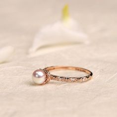 Vintage Akoya Pearl Diamond Ring, Dainty Gold Pearl Ring, Pink Pearl Engagement Ring, Tahitian Pearl Anniversary Ring, Rose Gold Custom Ring ✦PRODUCT DETAILS✦ → Main stone: Akoya Pearl 4.5-5mm → Side stone: Diamond 0.02ct ✦SPECIFICATIONS✦ MOISSANITE ✓ COLOR: D ✓ CLARITY: VVS1 ✓ CUT: EXCELLENT OR DIAMOND ✓ COLOR: F-G ✓ CLARITY: SI1-VS ABOUT US ♥ Our designer and craftsmen work to create and deliver the most refined pieces of jewelry to you. We carefully handpicked and sourced each gemstone to ens Delicate Engraved Rose Gold Ring For Wedding, Heirloom Rose Gold Pearl Ring Gift, Heirloom Rose Gold Pearl Ring, Dainty Rose Gold Jewelry For Marriage, Delicate Rose Gold Round Pearl Ring, Pink Diamonds Engagement, Pink Engagement, Heart Shaped Diamond Ring, Pink Diamond Engagement Ring