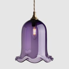 a purple glass light hanging from a ceiling