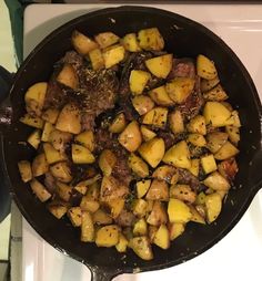 a pan filled with cooked potatoes on top of a stove