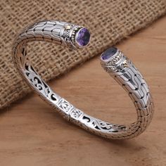 Accented with 18k gold, this cuff bracelet from Kadek Hendra in Bali is a stunner. The cuff is crafted of sterling silver and set with six carats of sparkling amethyst. A cleverly concealed hinge makes it easy to put on and take off the bracelet. Elegant Purple Gemstone Cuff Bracelet, Formal Sterling Silver Cuff Bracelet, Elegant Silver Amethyst Bangle, Elegant Silver Amethyst Cuff Bracelet, Cool Stuff To Buy, Silver Cuff Bracelet, Silver Cuff, Cocktail Ring, Cocktail Rings