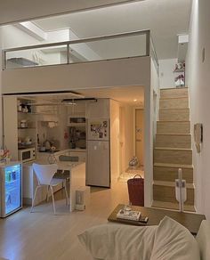 a living room filled with furniture next to a staircase