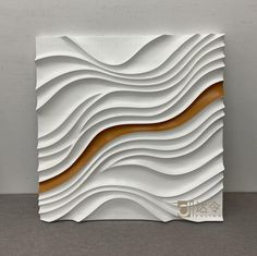 an abstract white sculpture with gold lines on it