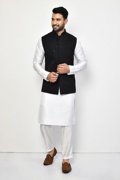 Black sleeveless bundi with sequin, thread embroidery in geometric pattern. Paired with full sleeve kurta and pant. - Aza Fashions Fitted White Nehru Jacket With Mirror Work, Sleeveless Nehru Jacket With Zari Work, Festive Sleeveless Nehru Jacket With Resham Embroidery, Sleeveless Nehru Jacket With Chikankari Embroidery For Diwali, Sleeveless Nehru Jacket With Chikankari For Diwali, Sleeveless Embroidered Nehru Jacket For Diwali, Embroidered Sleeveless Nehru Jacket For Diwali, Fitted Sleeveless Nehru Jacket With Resham Embroidery, Sleeveless Bandhgala For Eid