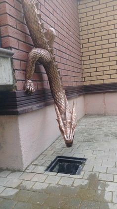 a statue of a dragon on the side of a building