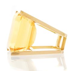 For Sale on 1stdibs - Circa 1970, 18k. This spectacular ring features a 65 carat citrine in a visionary, modernist setting. Stripped down to the essentials, form and function Modern Gold Topaz Ring, Modern Yellow Gold Topaz Ring With Polished Finish, Modern Yellow Gold Citrine Ring, Modern Citrine Ring In Yellow Gold, Modern Citrine Yellow Gold Ring, Vintage Fashion 1960s, Octopus Ring, 1890s Fashion, Modernist Jewelry