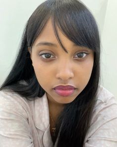 a woman with long black hair is posing for the camera