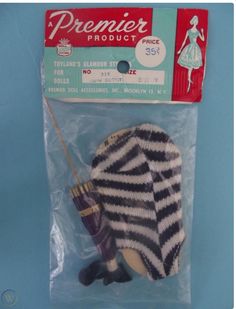 a package of knitted gloves and an umbrella in it's packaging on a blue background